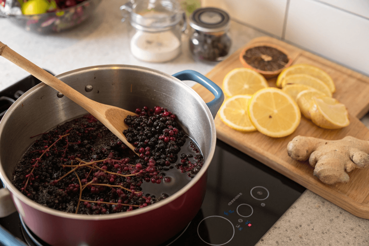 Boiling elderberries and ginger for elderberry tea preparation