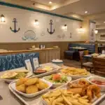 Captain D's Seafood 11 A cozy seafood restaurant scene featuring fish and chips, shrimp platters, and nautical décor at Captain D’s.