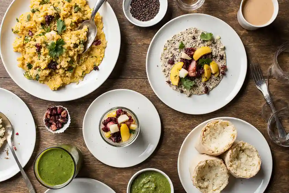 High protein vegan breakfast table with tofu scramble, smoothie, and oats