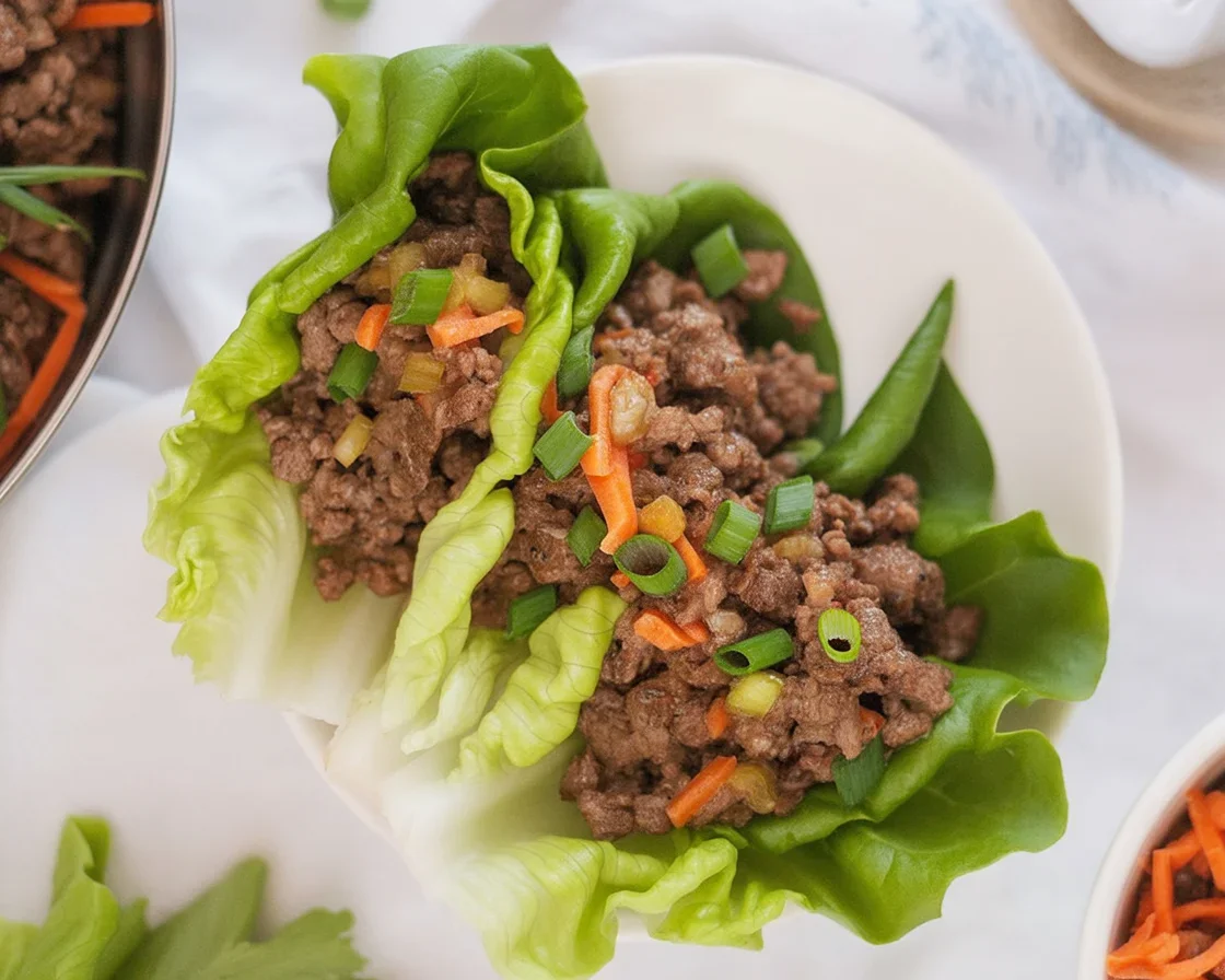 Asian Ground Beef Lettuce Wraps with bell peppers and carrots in lettuce cups.