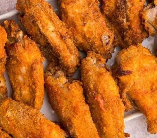Plate of crispy air fryer chicken wings with dipping sauce