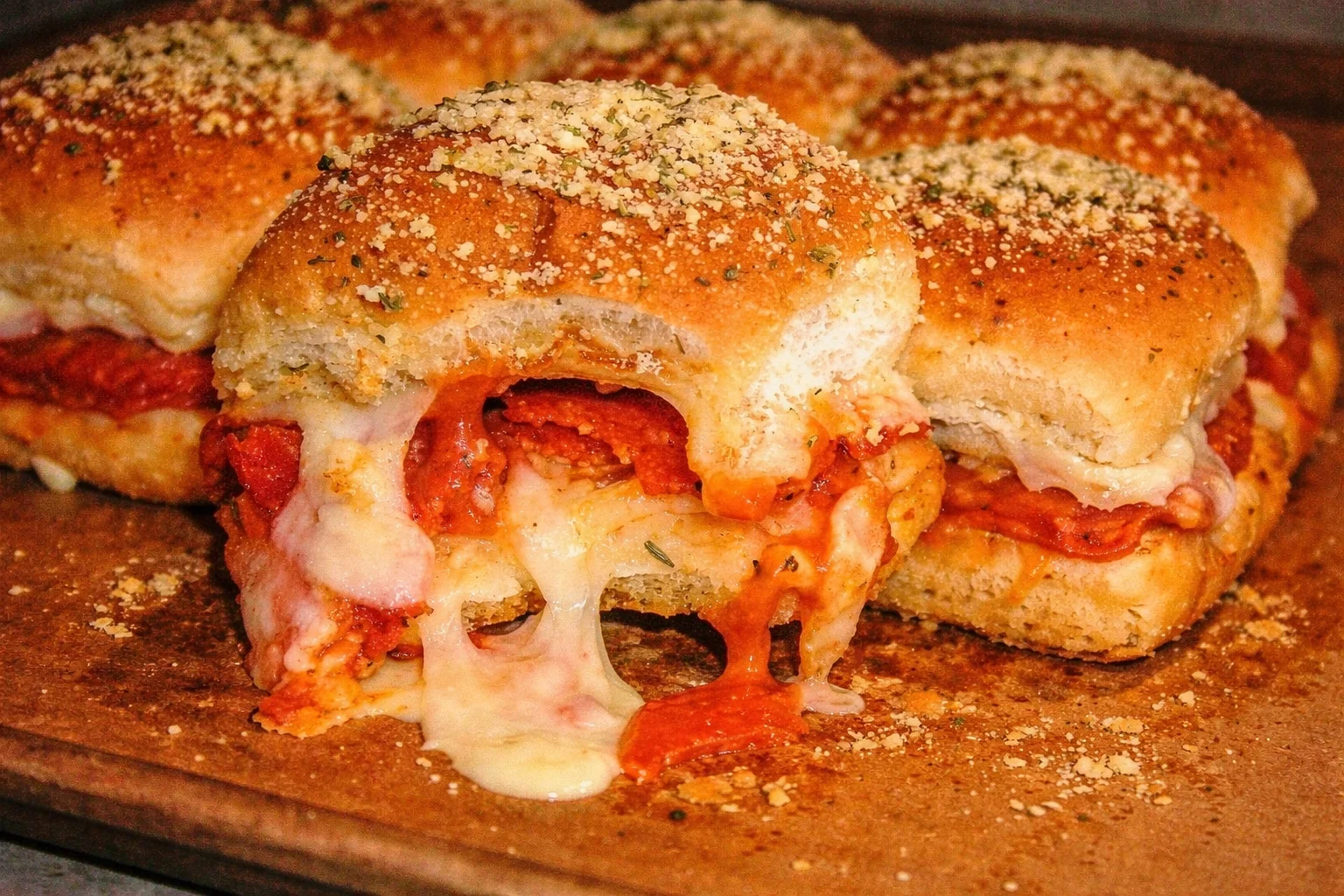 A plate of delicious pizza sliders topped with melted cheese and pepperoni.