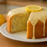 Moist lemon poppy seed cake topped with fresh lemon glaze and poppy seeds