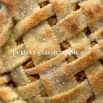 Freshly baked apple pie with golden crust and apple slices, perfect for dessert