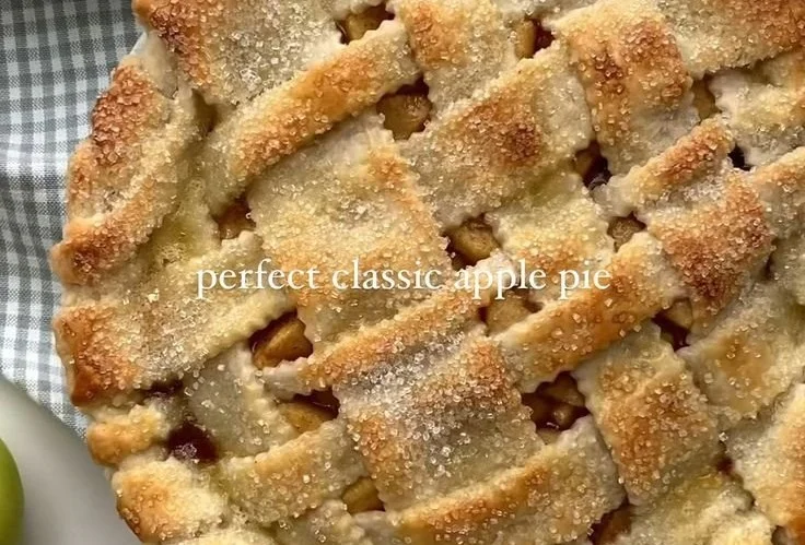 Freshly baked apple pie with golden crust and apple slices, perfect for dessert