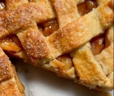 Delicious cinnamon apple pie served with a scoop of ice cream