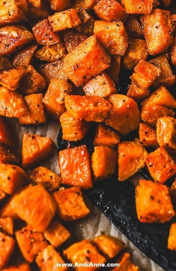 Perfectly roasted sweet potatoes on a baking sheet for a healthy side dish.
