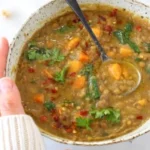Bowl of sweet potato and lentil stew with herbs and spices, healthy vegetarian recipe