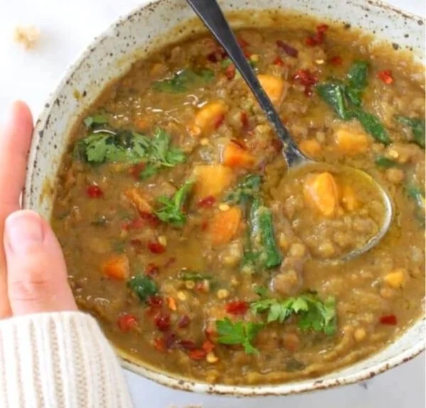 Bowl of sweet potato and lentil stew with herbs and spices, healthy vegetarian recipe