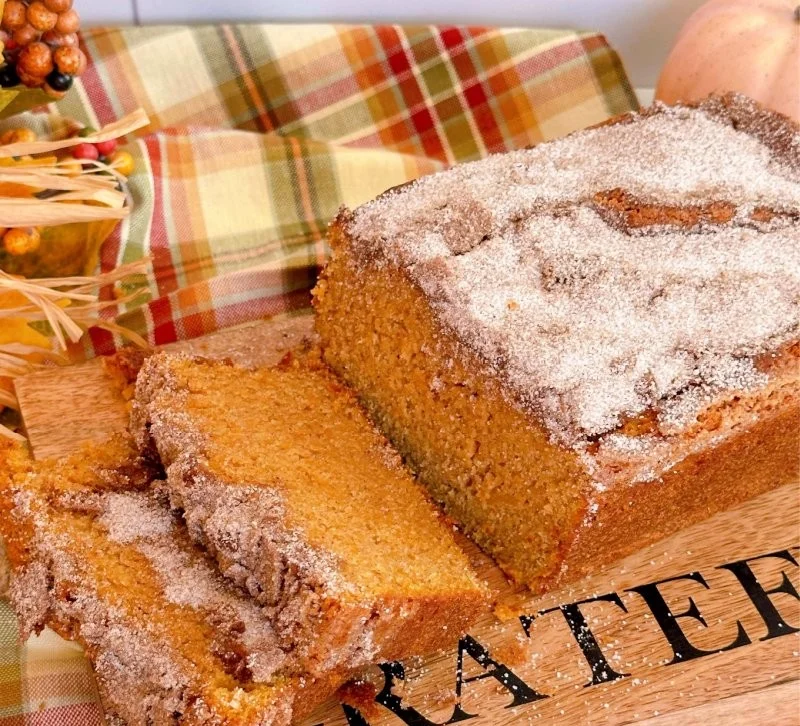 Homemade sweet potato cinnamon bread loaf on a wooden cutting board